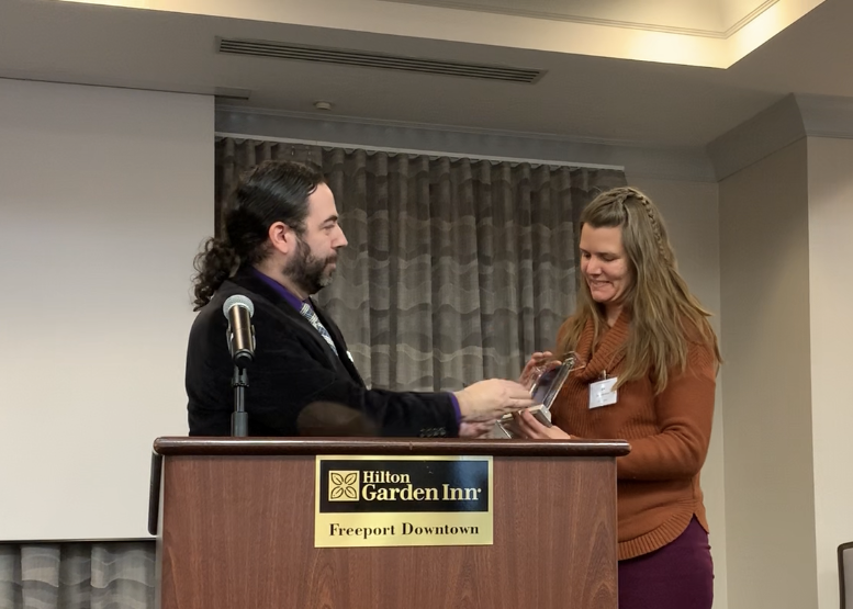 Scott Gagnon presents an award to Liz Blackwell-Moore