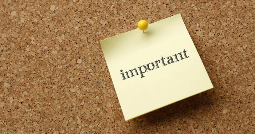 A sticky note tacked to cork board says it is important