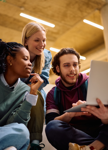 Adult Students watching something on a laptop at a school setting_Resized_359w